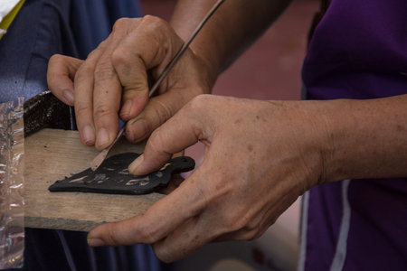 Thai style hand craft, artist carving  thai stlye on wood with draft paperの写真素材