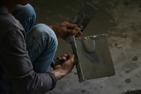 plasterer concrete worker at wall of house constructionの写真素材