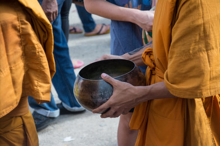 Buddhist monks are given food offering from people for End of Buddhist Lent Dayの写真素材