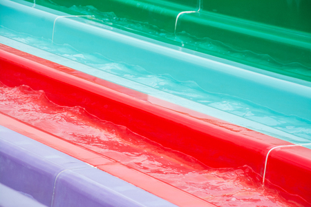 colorful plastic water-slide in swimming poolの写真素材