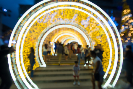 abstract  blurred   background of people walk with tunnel decoration lightingの写真素材