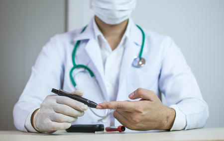 Doctor checking blood sugar level.の写真素材