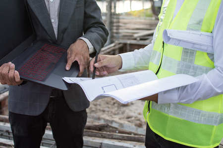 Engineer and an architect working at construction siteの写真素材