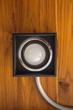 light bulb in black lamp on wooden ceiling