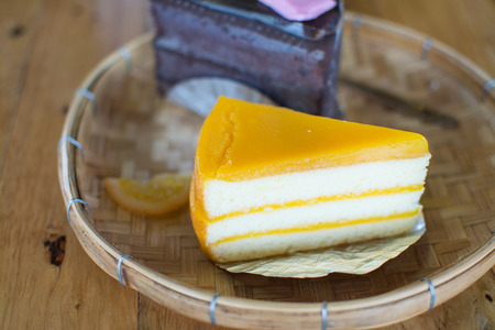 Orange cake with brownie  on wood tableの写真素材