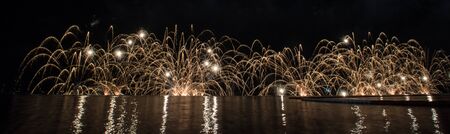 Beautiful firework display for celebration over the seaの写真素材