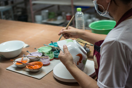 painting chicken patternon on white ceramic bowl , the famous chicken bowl and ceramic of Lampang ...