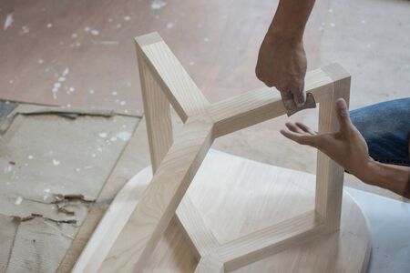 Using sandpaper scrub plank wood for making table, furniture の写真素材