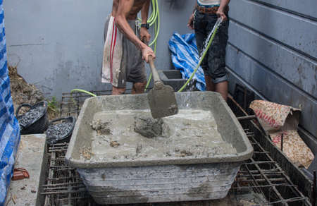 Mixing a cement in salver for applying constructionのeditorial素材