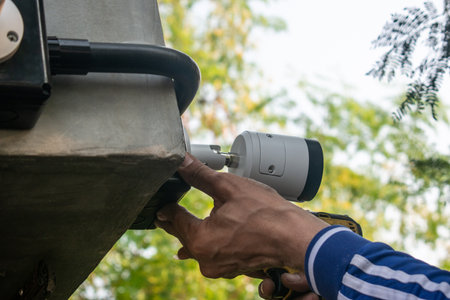 Technician installing CCTV camera system for security areaの写真素材