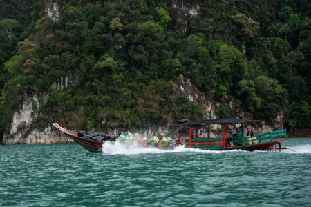 Suratthani, Thailand - February 23, 2028: longtail boat on Cheow Lan lake at Khao Sok national park....