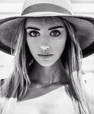 Black and white close-up portrait of a young beautiful caucasian girl with a pretty face and big...