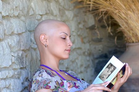 Cancer survivor while reading her book in positive attitudeの写真素材