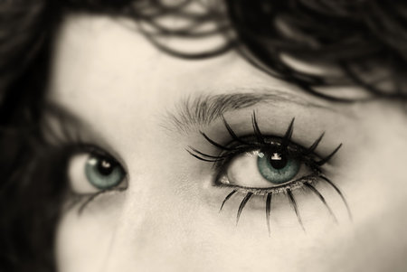 Close up to beautiful model and her fake spider eyelashes,bronze glimmer glass lens filter used 