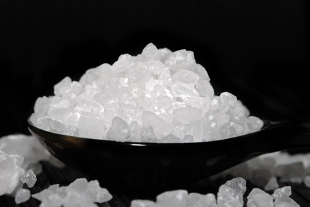 Sea Salt on black spoon,black background