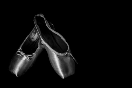 Ballet Shoes isolated on Black Background, high contrast with vignette black and white in studioの写真素材