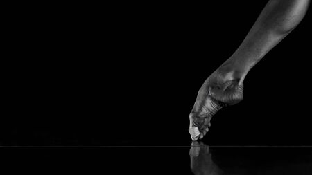 Closeup ballerina on pointe on reflective platform, isolated on Black Backgroundの写真素材