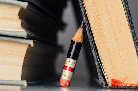 Horizontal Photo with Old Books and Small Perfect Pencilの写真素材