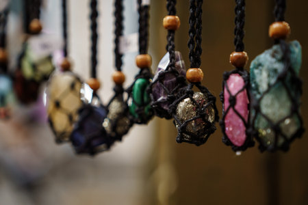 Raw crystal pendants on macrame cords displayed in a row with natural wood beads