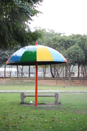 umbrella   bench in parkの写真素材
