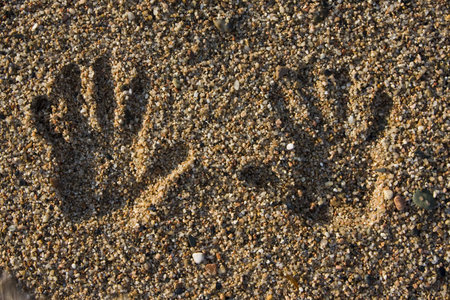 hand print on the rocky beach