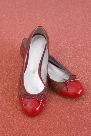 pair of red shoes on red materialの写真素材