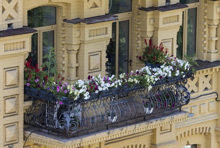 Balcony covered with flowers, delicate railing. Urban architecture. Kiev Ukraineの写真素材