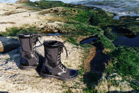 Unisex beige khaki boots and jeans on a background. Caucasus, Russia