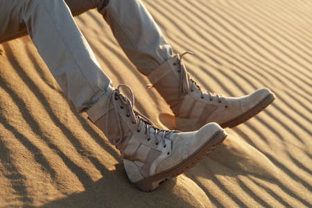 Legs of people in khaki clothes and beige shoes. Caucasus, Russiaの写真素材