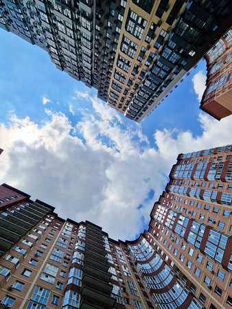 Multi-storey building in a modern residential complex and a view of the sky. Business buildings in...