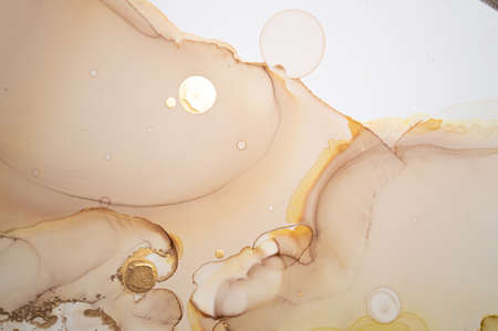 Golden Abstract Liquid. Alcohol Ink on Paper. Metallic Wave Mix. Ink Marble Painting. Abstract Background Liquid. Ethereal Creative Wallpaper. Oil Abstract Background Liquid.の写真素材