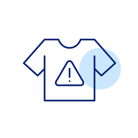Tshirt and hazard alert with exclamation mark. Clothing safety warnings. Flammability or harmful dyes. Pixel perfect, editable stroke vector iconのイラスト素材