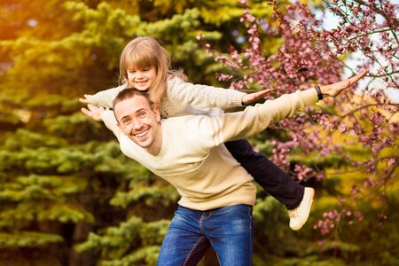 Happy father and child spending time outdoors. Lets fly. Family supportの写真素材