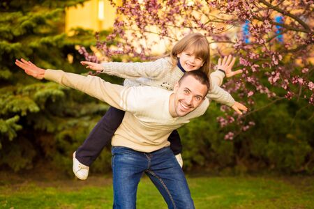 Happy father and child spending time outdoors. Lets fly. Family supportの写真素材