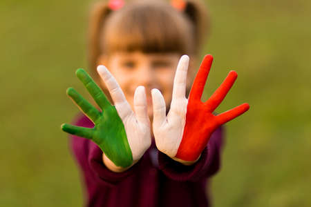 Painted kid hands in italy flag colors. Creativeの写真素材