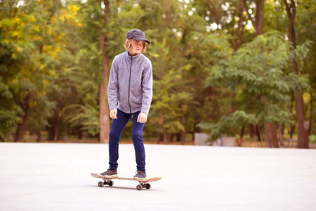 Skater girl on skatepark moving on skateboard outdoors. Copy spaceの写真素材