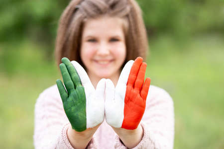 Mexico flag painted on teen girl hands, focus on hands. Mexican Independence Day 16 September. February 5 Day of Conference. February 24 National Flag Dayの写真素材
