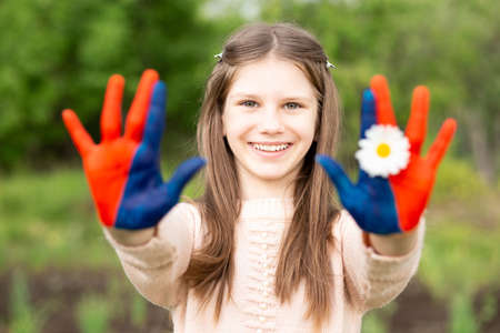 Hands of kid girl painted in Mongolia flag color. July 10 National Flag Day. Mongolian memorial holiday 29th of Decemberの写真素材