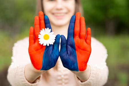 Hands of kid girl painted in Mongolia flag color show stop gesture. Focus on hands. July 10 National Flag Day. Mongolian memorial holiday 29th of Decemberの写真素材