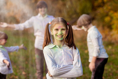 Child playing with color in holi festival. Holi celebrations, girl playing holi in India.の写真素材