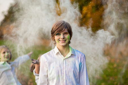 Child playing with color in holi festival. Holi celebrations, girl playing holi in India.の写真素材