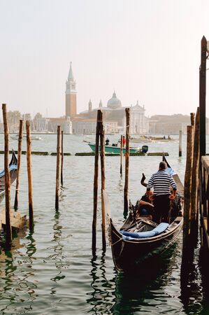 Gondola and Venice near the bridgeの写真素材