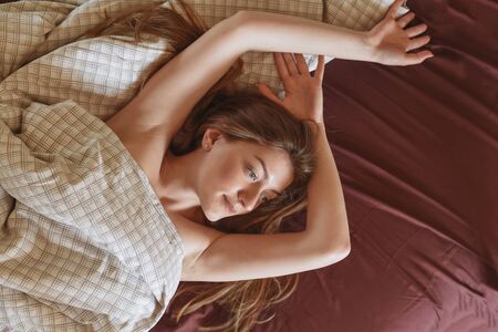 Girl woke up in bedの写真素材