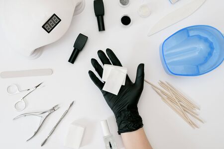 Tools for manicure hand in black gloveの写真素材