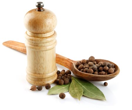spices in wooden spoon with laurel leaves isolated on white backgroundの写真素材