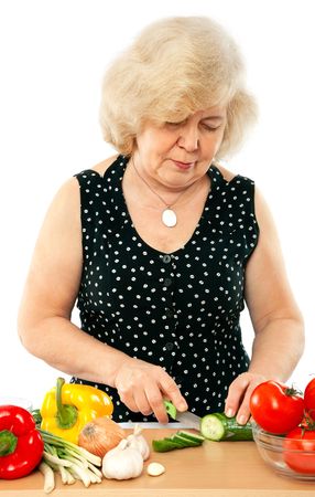 old woman cooking food isolated on white backgroundの写真素材