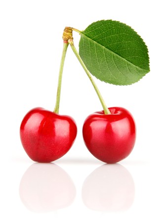 fresh cherry fruits with green leaves isolated on white backgroundの写真素材