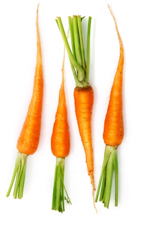 fresh carrot fruits with green leaves isolated on white backgroundの写真素材