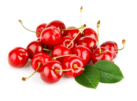 fresh cherry fruits with green leaves isolated on white backgroundの写真素材