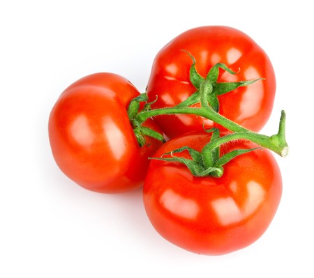 fresh tomato fruits with green leaves isolated on white backgroundの写真素材
